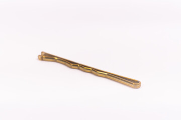 Small gold black metal hairpin isolated on white background closeup