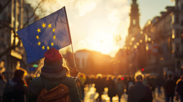 Woman holds the European Union flag in her hand at a demonstration for accession and membership, peace, freedom and democracy. Joining the EU.
