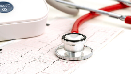 Stethoscope on heart cardiogram, heart examination concept