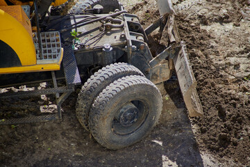 The bulldozer bucket at work on earthworks close-up, construction work with a bulldozer, bulldozer...