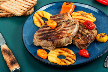 Grilled meat steak with pineapple.