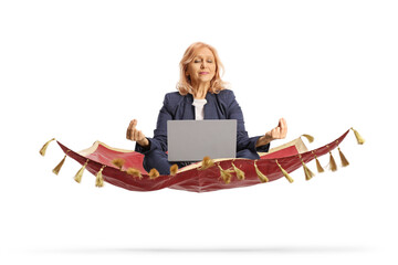 Businesswoman with a laptop computer sitting in a meditation pose on a flying carpet
