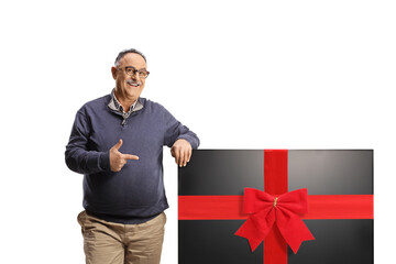 Mature man pointing at a new lcd tv screen