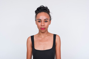 Confident mixed-race woman in black bodysuit on white background