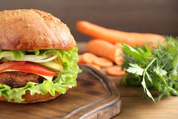 Delicious vegetarian burger served on wooden table, closeup