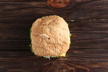 Delicious vegetarian burger on wooden table, top view