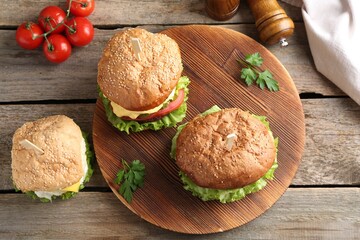 Delicious vegetarian burgers served on wooden table