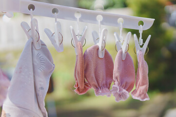 Baby gloves and socks dried under sunlight