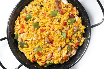Yellow rice with chicken and vegetables isolated on white background