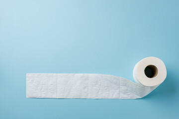Top view of toilet paper roll on blue background