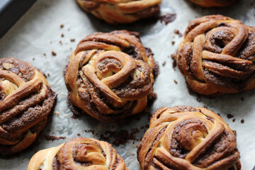 Bakery. Cinnamon Buns on Baking Tray. Breakfast Buttery Pastry.