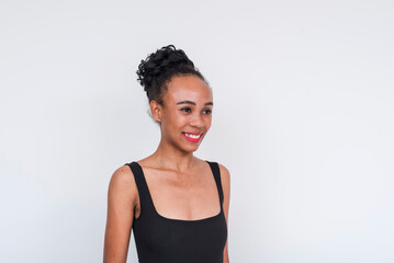 Smiling mixed-race woman in black bodysuit isolated on white background
