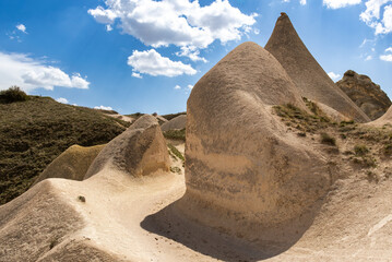 A path through the tent rocks , fairy chimneys under the cloudy sky at the Cappadocia region under...