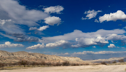 An arid land under the cloudy sky at Cappadocia