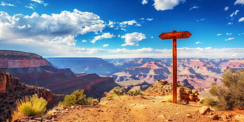 A breathtaking view of the canyon under a cloudy sky, with a wooden signpost in the foreground.