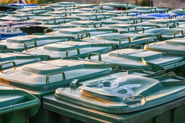Many green wheelie bins lined up outside for tourists in Southwold, England - obrazy, fototapety, plakaty
