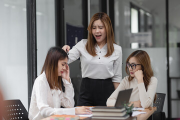 Asian businesswoman team worry about his job with a financial report document at meeting room, Problem work.