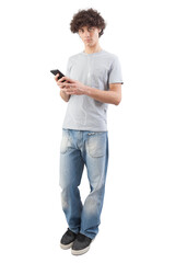 Young man, smiling and handsome, using his smartphone with earphones to listen to music or voice message. He looking into the camera with his blue eyes, isolated on white background in full-body shot