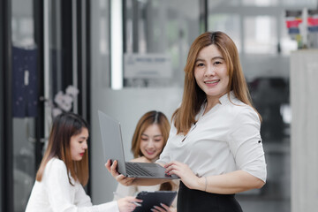 Group of young asian businesswoman working and brainstorming in workshop and analyzing marketing reports startup project infographics in the office.