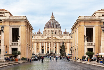 View of St. Peter's Basilica in the Vatican city against blue sky background, Rome, Italy.