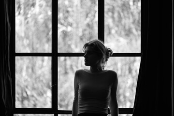 Contemplative Woman Gazing Out a Window in Monochrome
