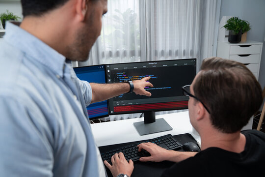 IT developers pointing on software development information on two screens with coding program in application and website. Technical engineer coder analyzing in safety program concept. Sellable.