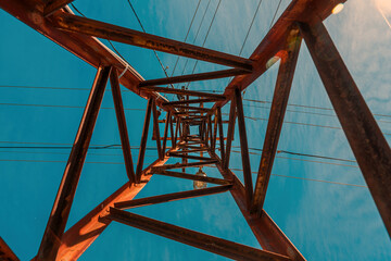 Old worn electricity pylon transmission tower - obrazy, fototapety, plakaty