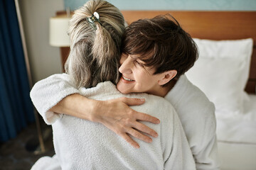 Tender moment between a loving senior lesbian couple in a hotel.