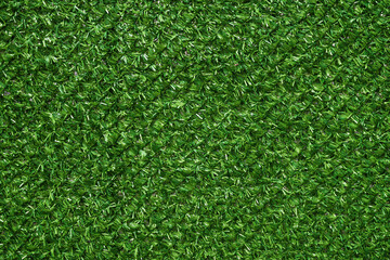 Texture of artificial green grass fencing panel as background