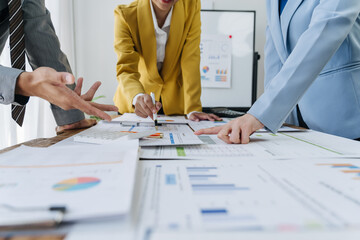 Close up business adviser partnership coworkers using a tablet to chart company financial statements report and profits work progress and brainstorming, discussing and analyzing business strategy.