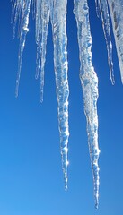 Fototapeta premium Icicles hanging and forming on the edge of a roof during cold winter weather conditions