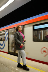 Fototapeta premium Beautiful lonely girl in black posing in the subway.