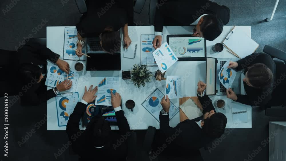 Poster top down aerial view of business people discussing about financial strategy on table with document a