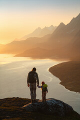 Family father and child hiking in mountains traveling together exploring Norway adventure healthy...