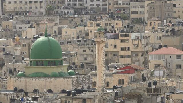 Dome and minaret of a mosque in a residential neighborhood of the old city in Nablus in the West Bank
