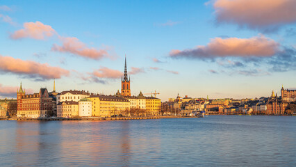 Sunset over Riddarholmen island, Stockholm, Sweden. Medieval buildings, church and clouds. Blue...