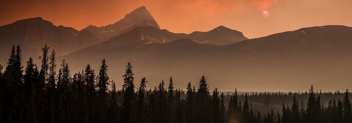  Inferno Sky: Dramatic Red Clouds Illuminated by Forest Fires in Banff National Park, Alberta,...