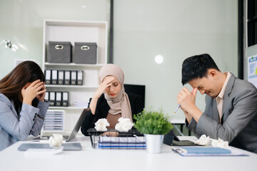 Furious Asian businesspeople arguing strongly after making a mistake at work in office