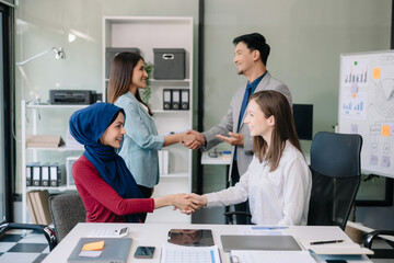 Obraz premium Business partnership handshake concept.Photo two coworkers handshaking process..