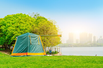 Green tent on the lakeside camping