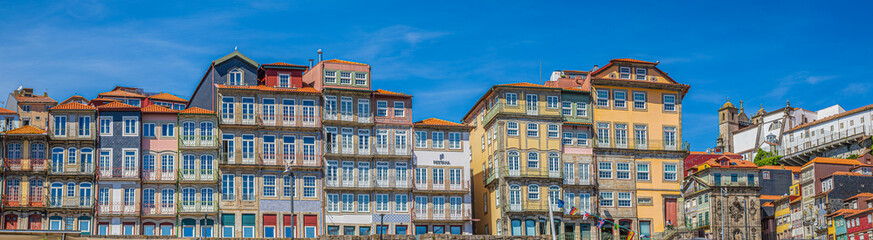 Panoramic view with old multi-colored houses in old town over Douro river. Porto Ribeira, along da Cais da Ribeira, Porto, Portugal