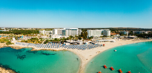 Ayia Napa, Cyprus - 15th april, 2023: aerial fly over Luxury hotel buildings with pools by beach...