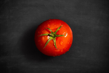 Fresh tomato with water drops on black background, Organic vegetables, top view
