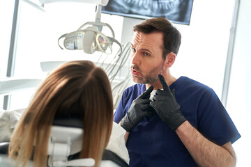 Dentist giving information to the patient