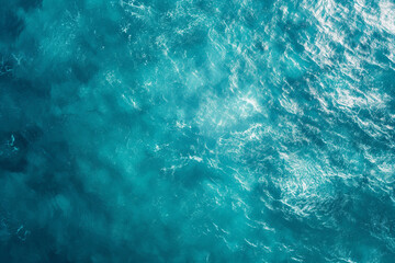 Aerial view of a turquoise water surface texture in a flat lay shot from a top down perspective in a close up