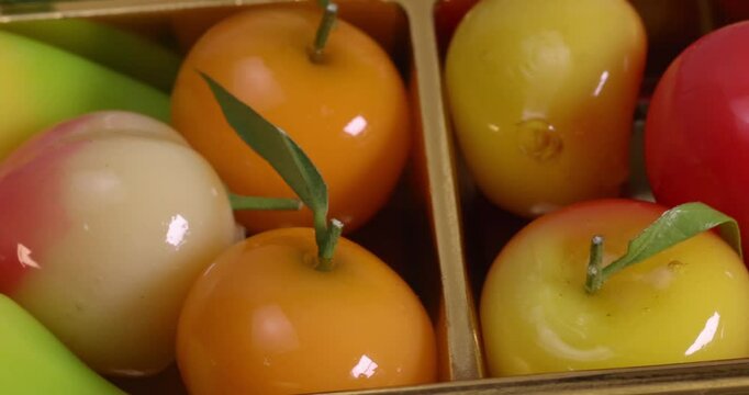 Colourful fruit vegetable shaped Thai sweet mung bean coconut milk desert luk chap candy variety pan rotate move
