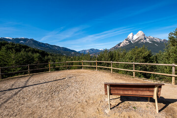 Serene resting spot with a wooden bench overlooking the stunning Pedraforca mountain against the sky in Catalonia, Spain