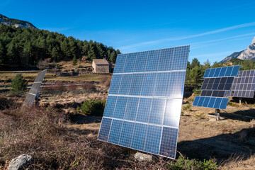 Capturing the serene Pedraforca mountain range from Catalonia, Spain, this image evokes peace as solar panels rest in a rustic setting, blending old and new