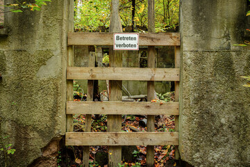 Lost place door with sign do not enter of a hydroelectric power station