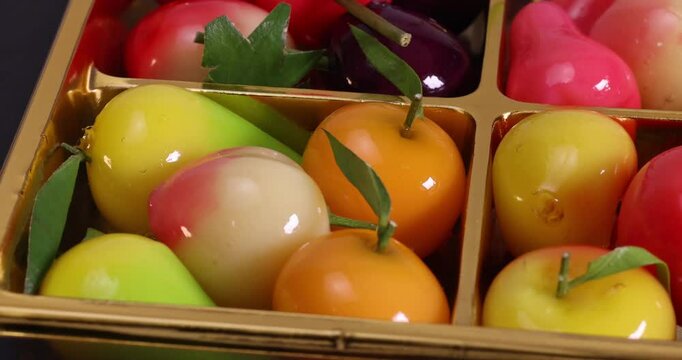 Colourful fruit vegetable shaped Thai sweet mung bean coconut milk desert luk chap candy variety pan rotate move